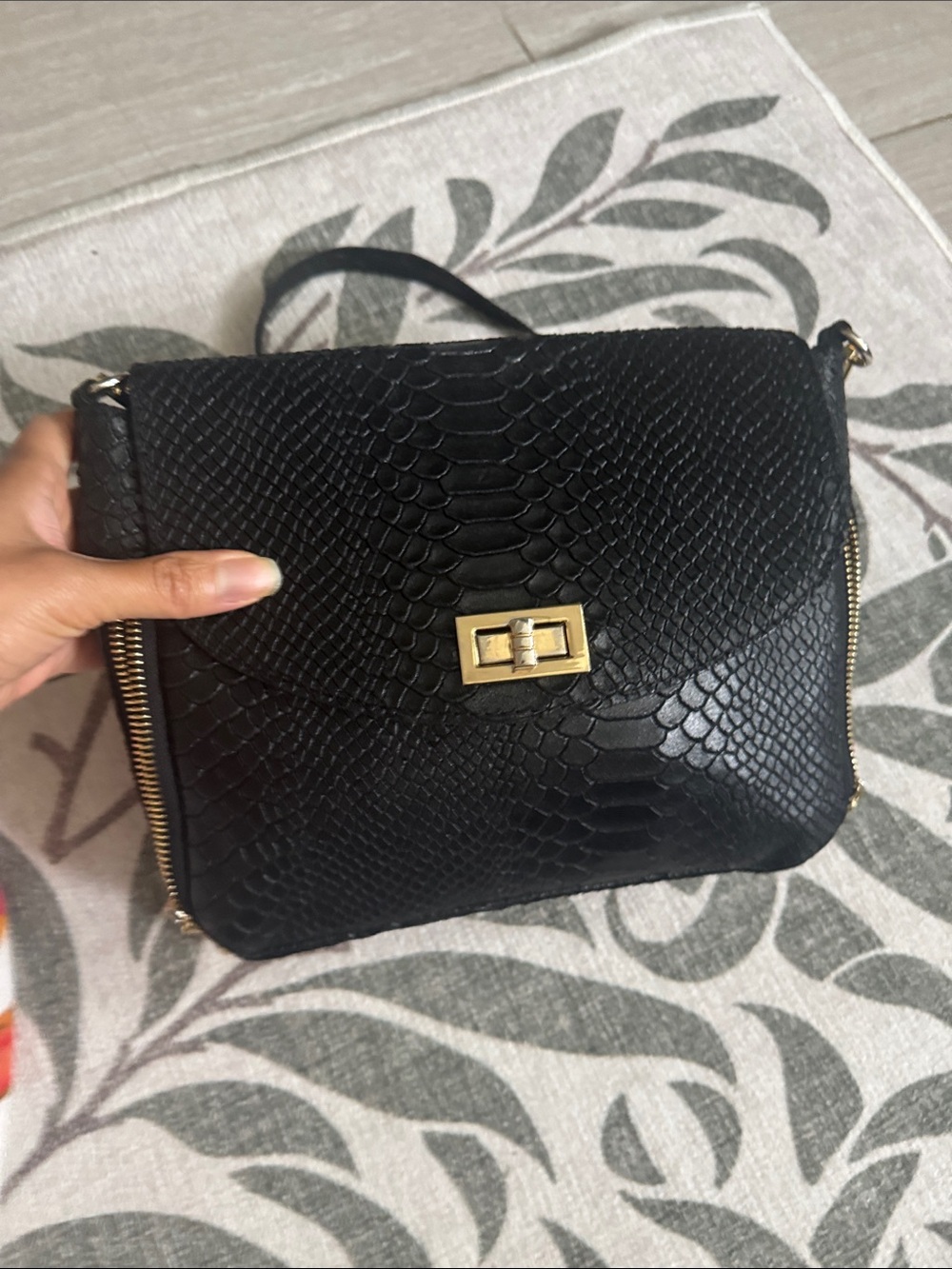 This black leather Roberta M. shoulder bag features a distinctive croc embossing